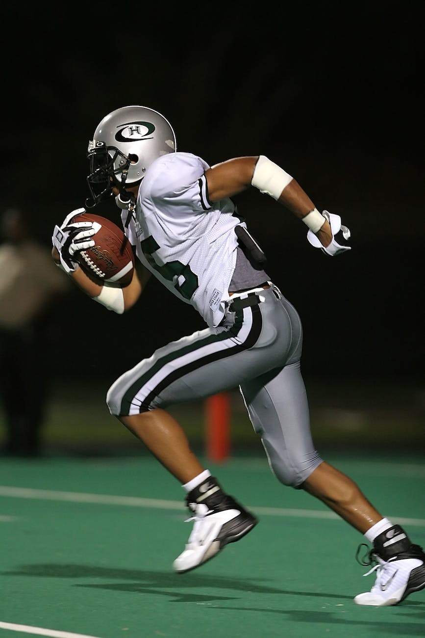 football player holding football