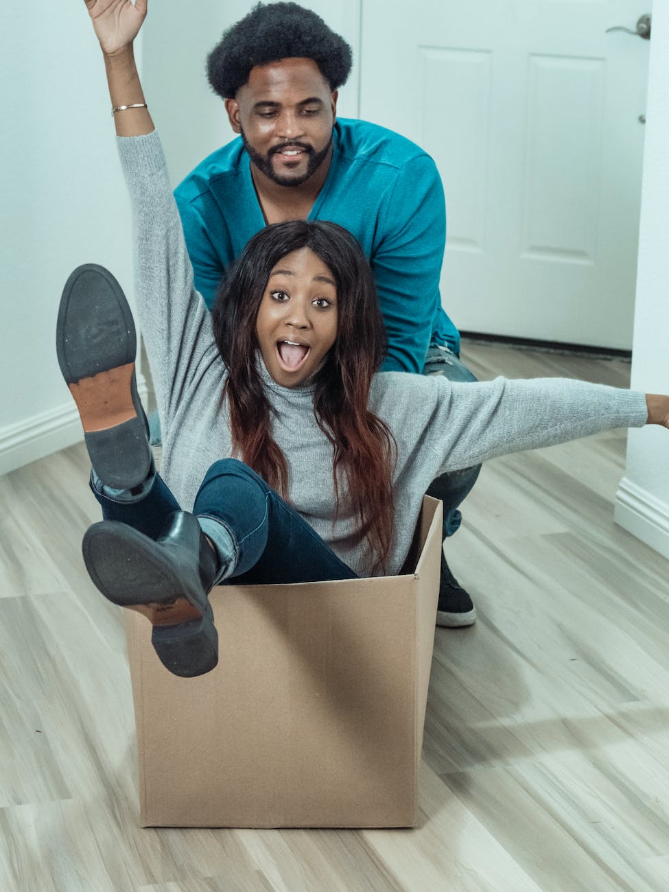 man pushing woman inside a box