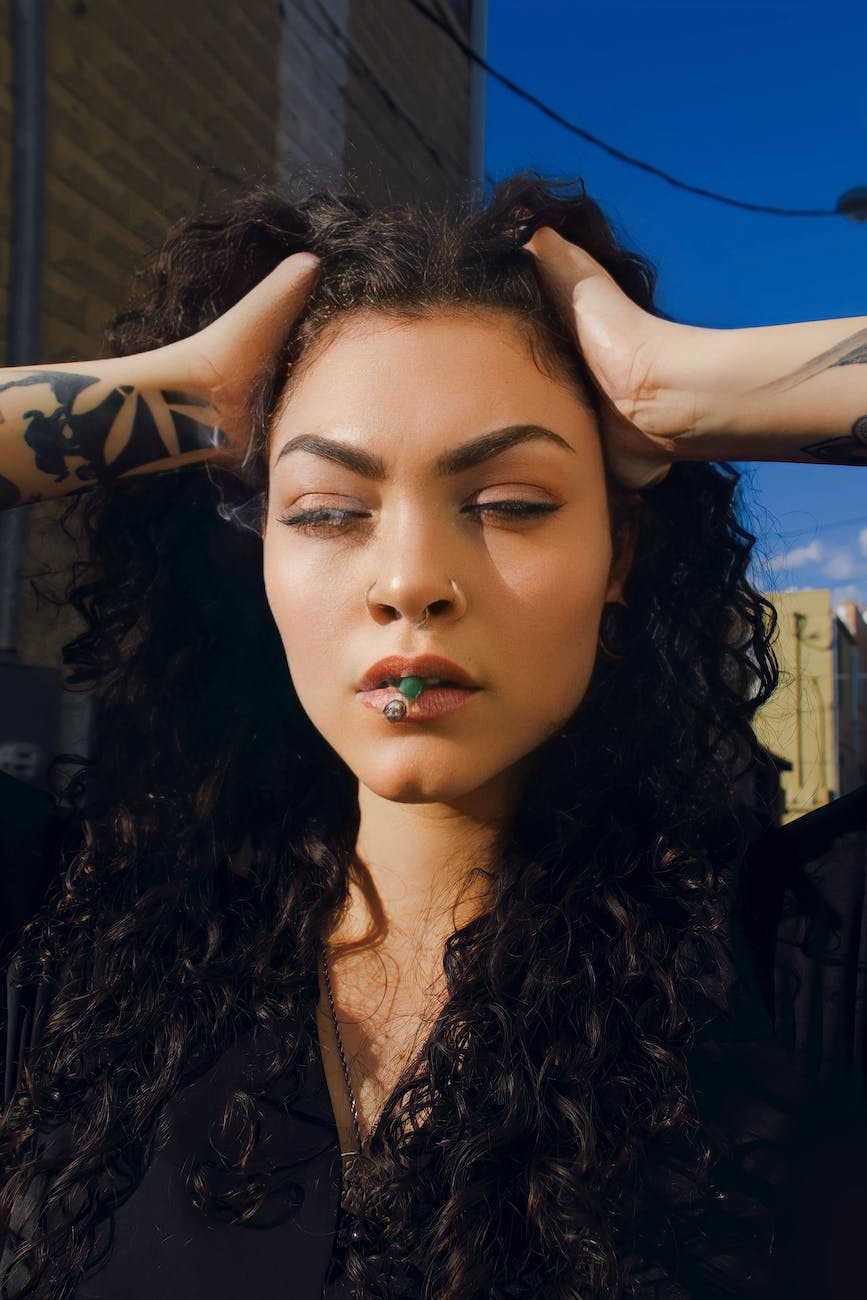 stoned brunette with cigarette in mouth