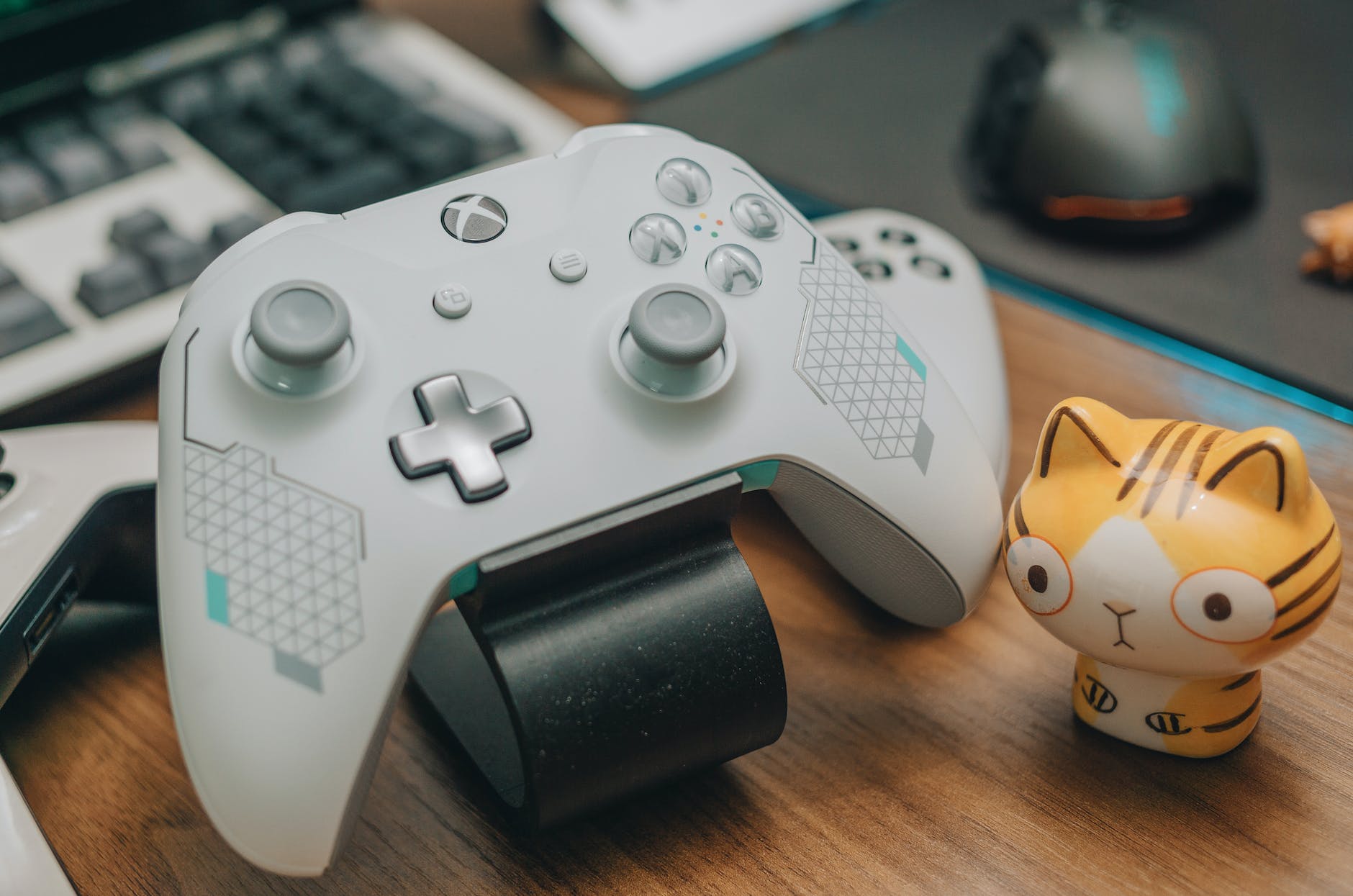 white xbox controller on brown wooden surface