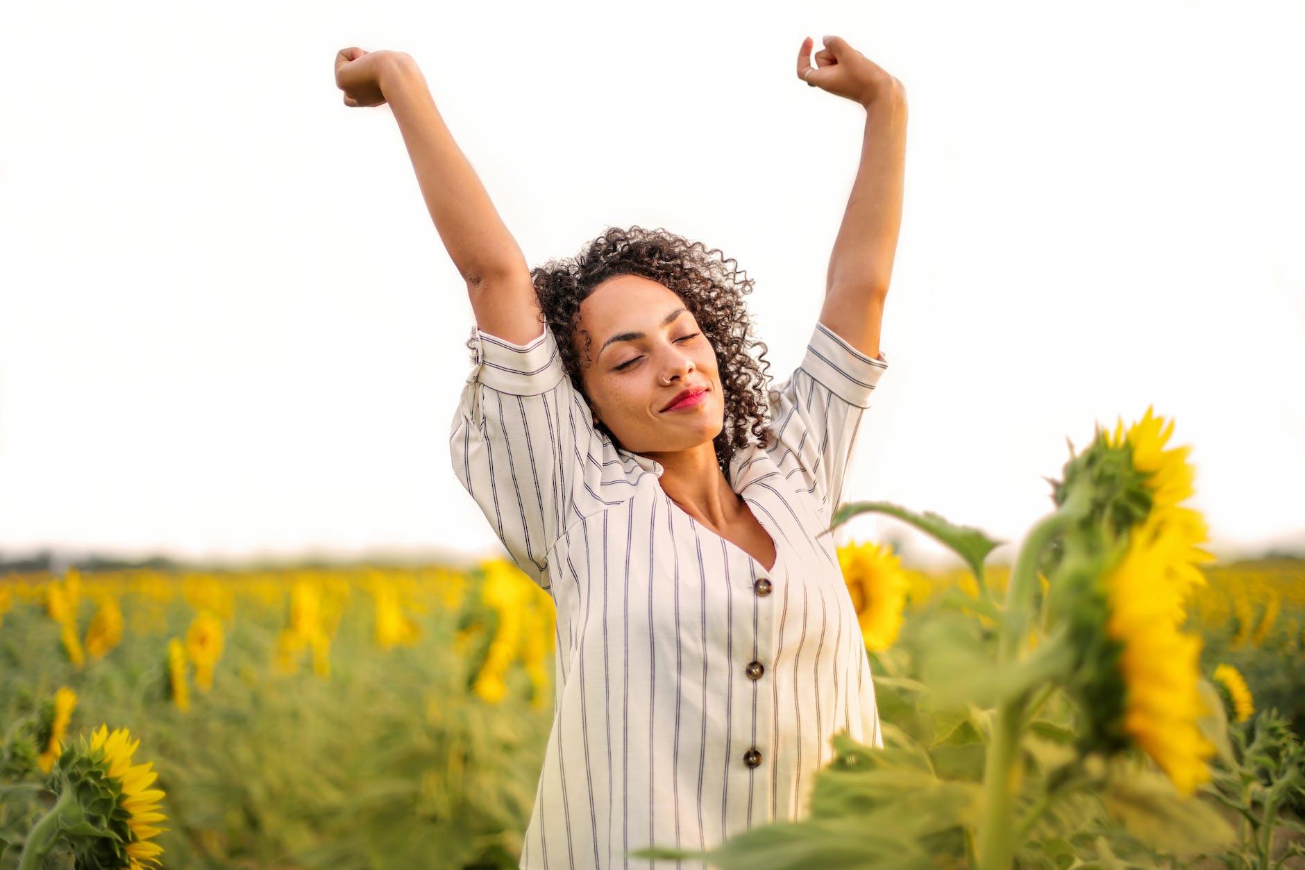 photo of woman putting her hands up