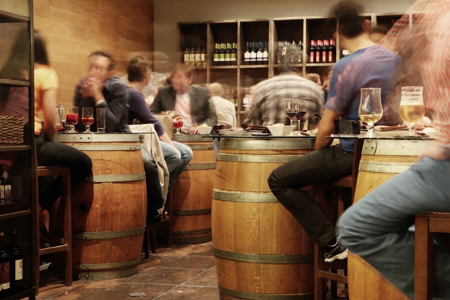 person sitting near the brown wooden barrel table