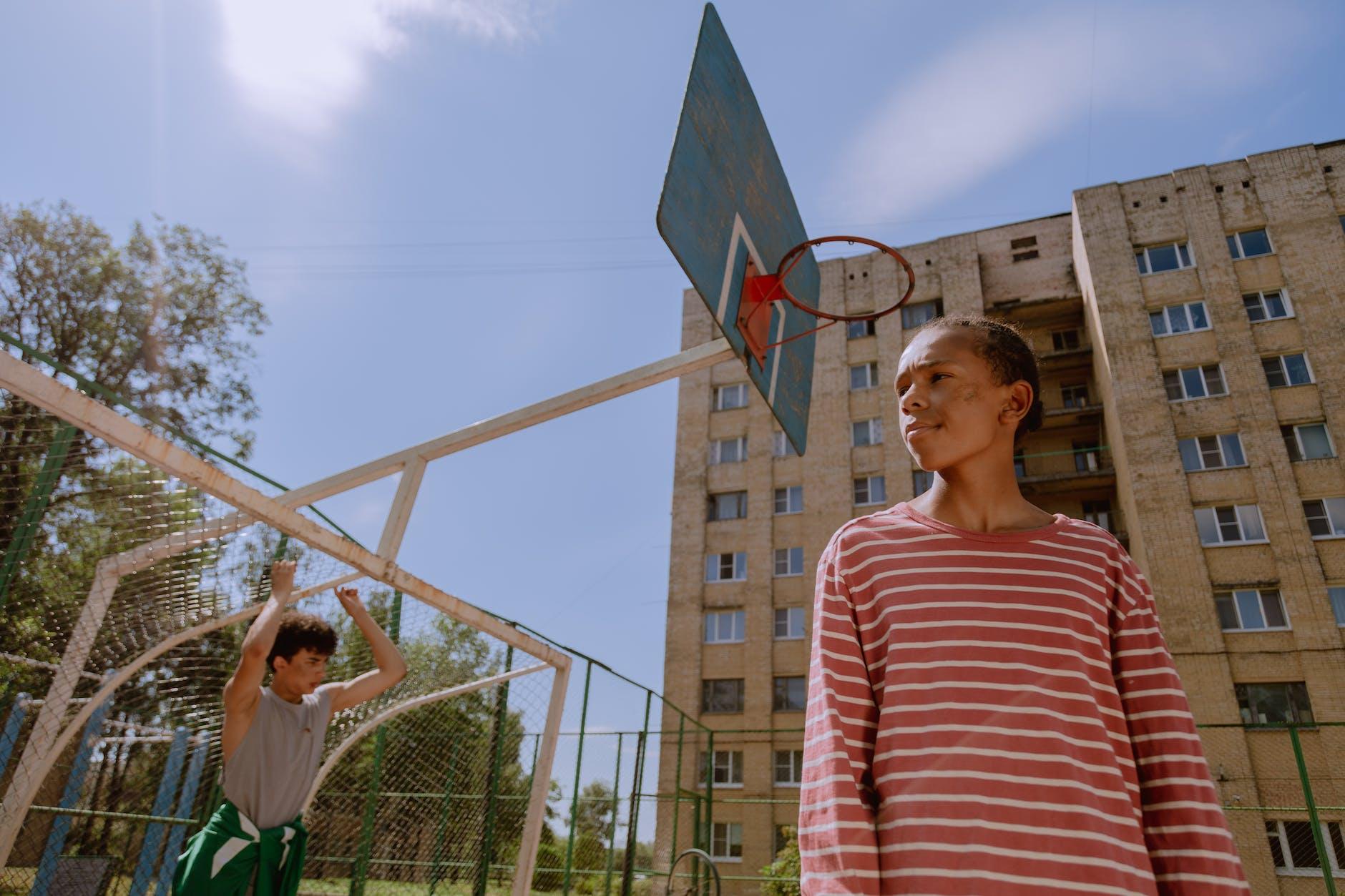 low angle shot of a teenager in a basketball court