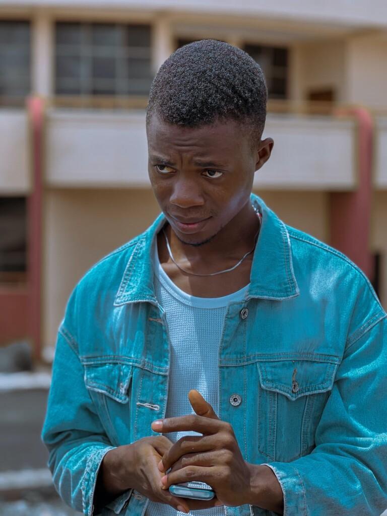 photo of a young man in a denim jacket
