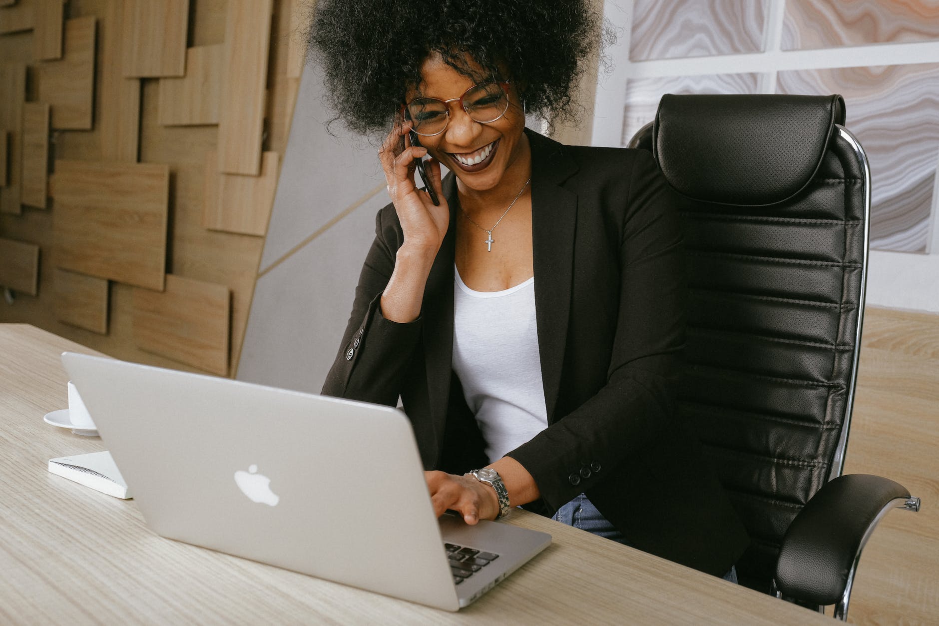 woman in black blazer sitting on black office chair