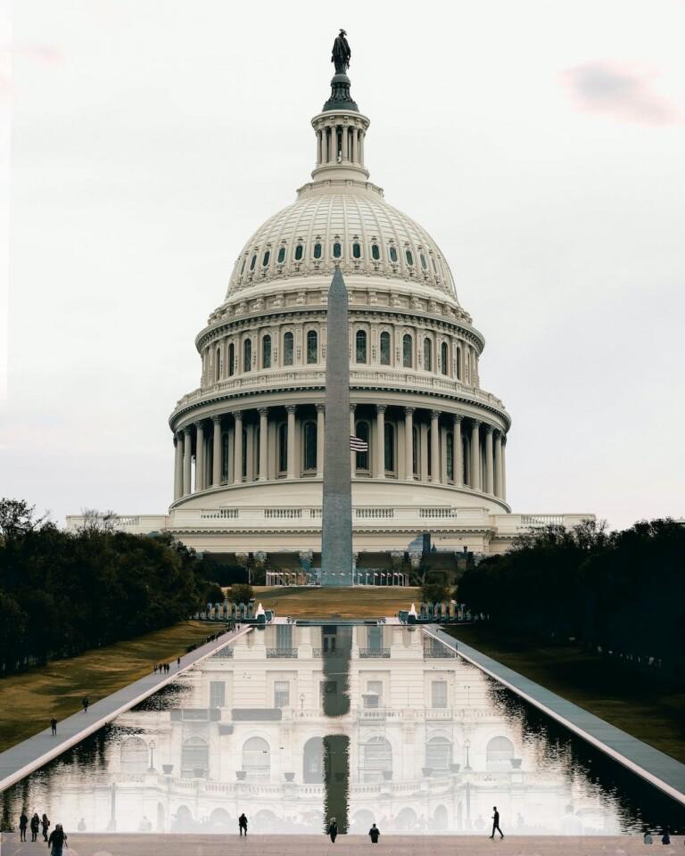 washington state capitol facade reflecting in pond under white sky