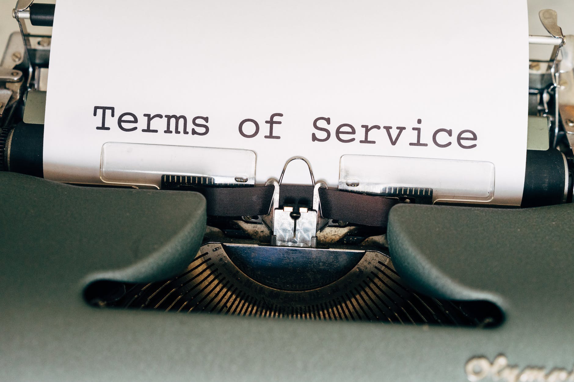 black and green typewriter with white paper