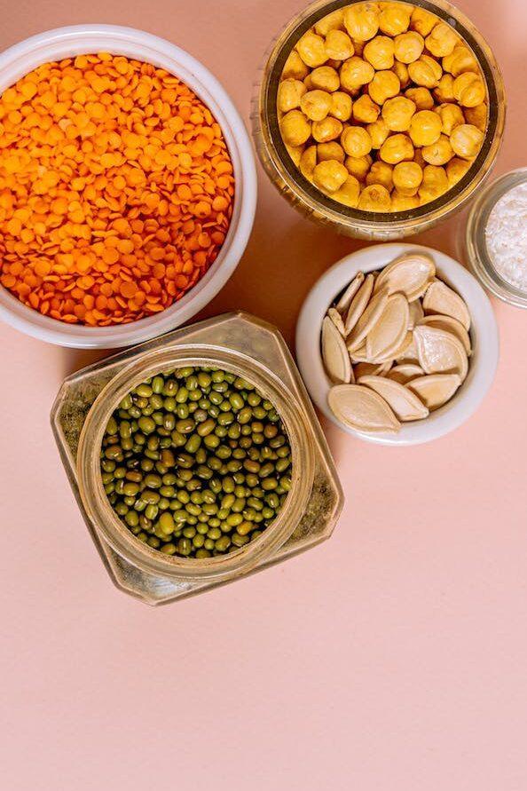 containers with chickpeas beans and lentil seeds