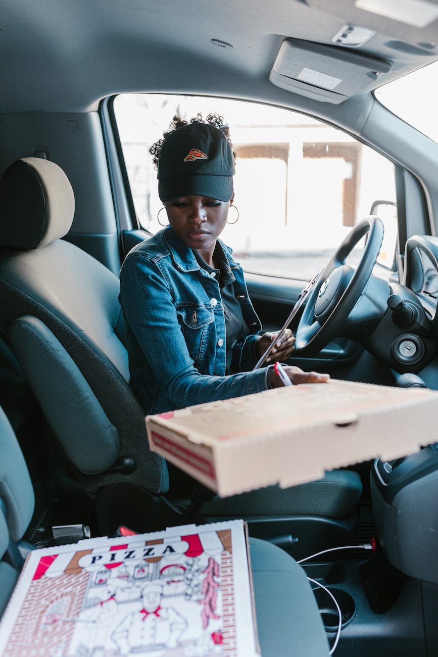 a pizza deliverywoman wearing a denim jacket