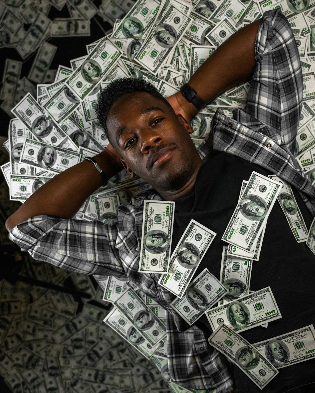 man lying down with money