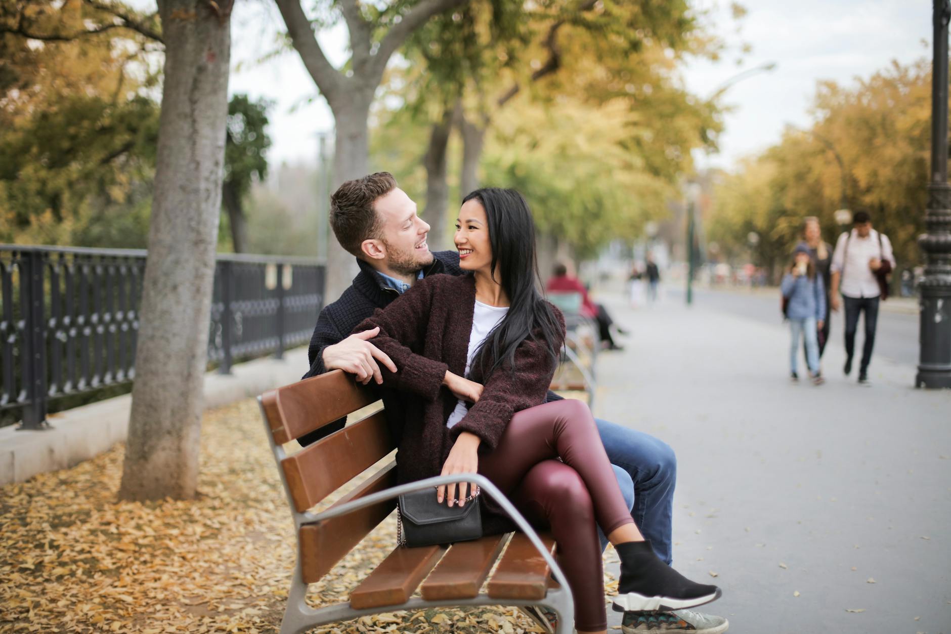 couple sitting on wooden bench