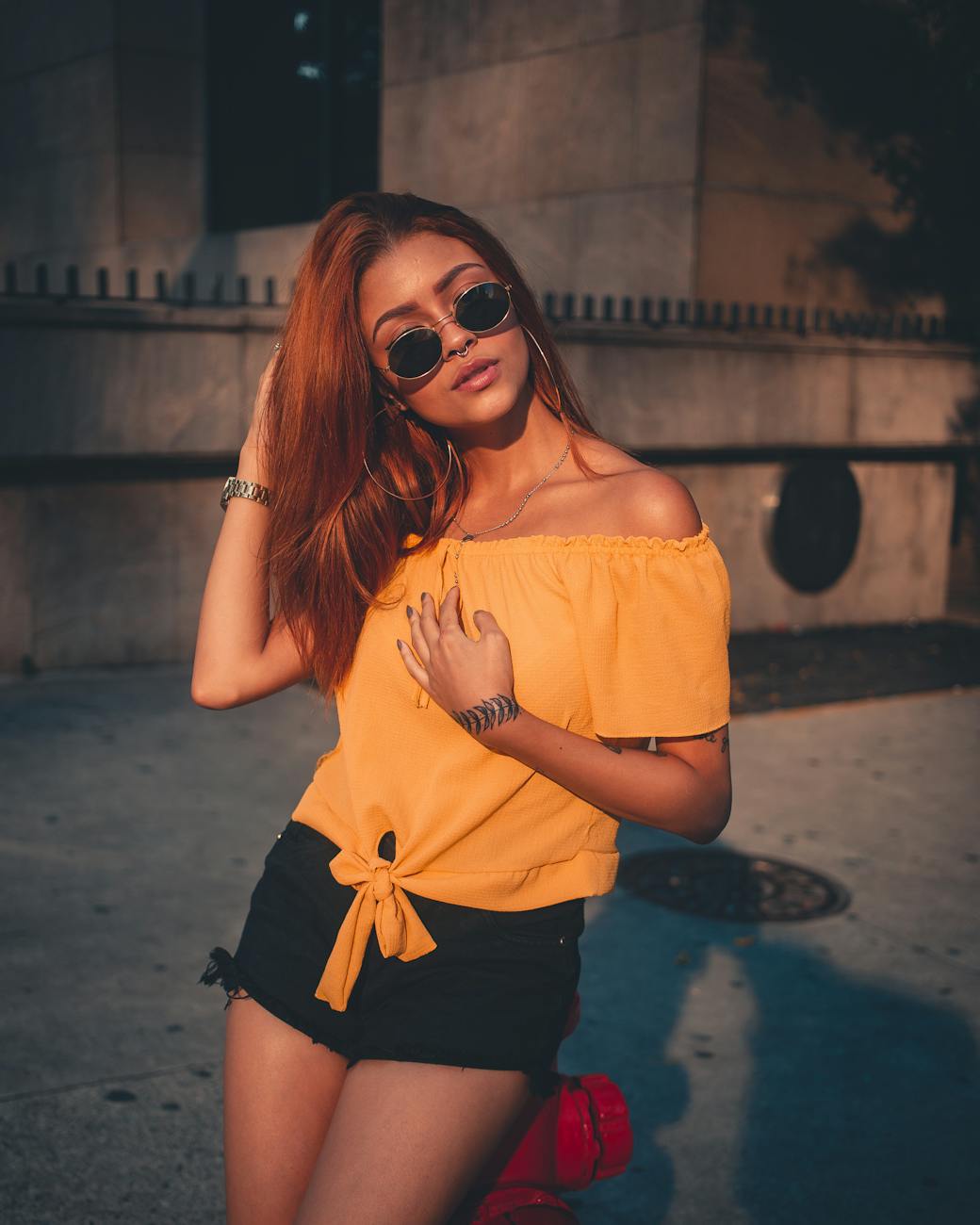 woman wearing yellow off shoulder blouse and black shorts