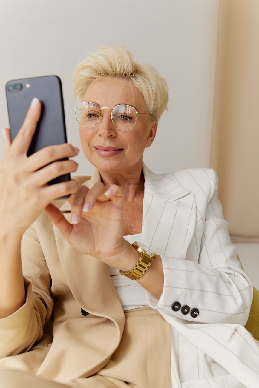 a woman with eyeglasses using her cell phone