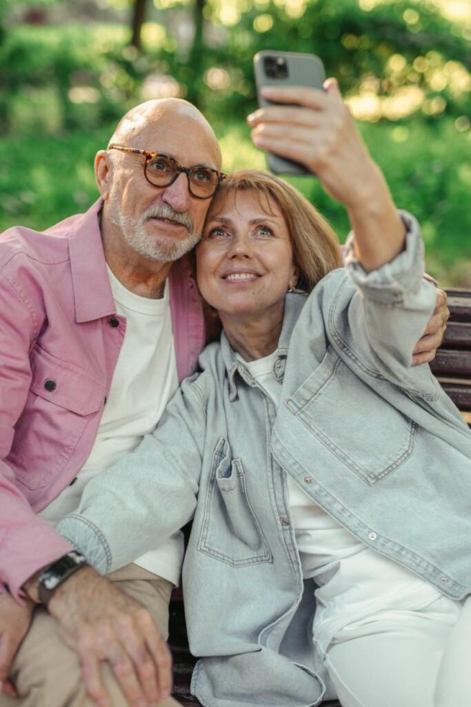 an elderly couple taking a selfie