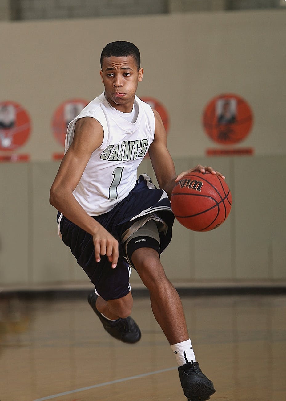 man dribbling basketball