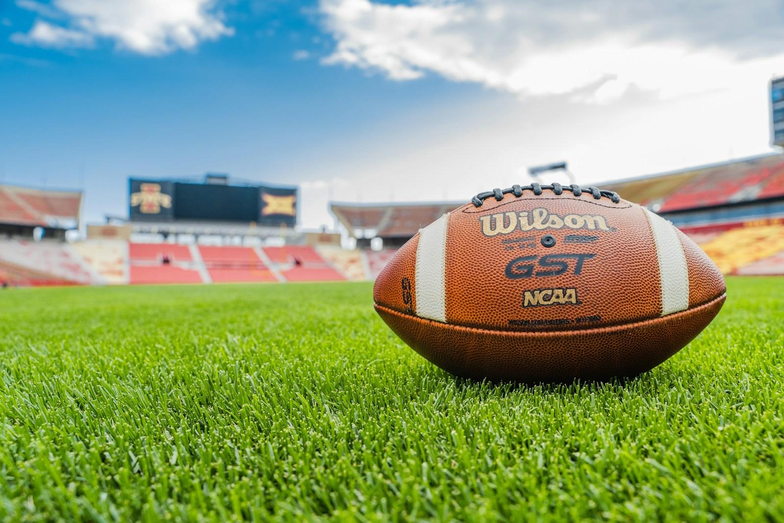 a football sitting on top of a lush green field