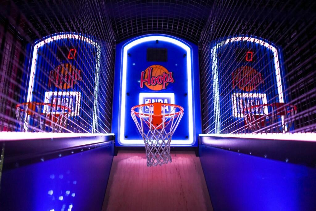 A colorful indoor arcade game showcasing basketball hoops in a vibrant setting, perfect for entertainment venues.