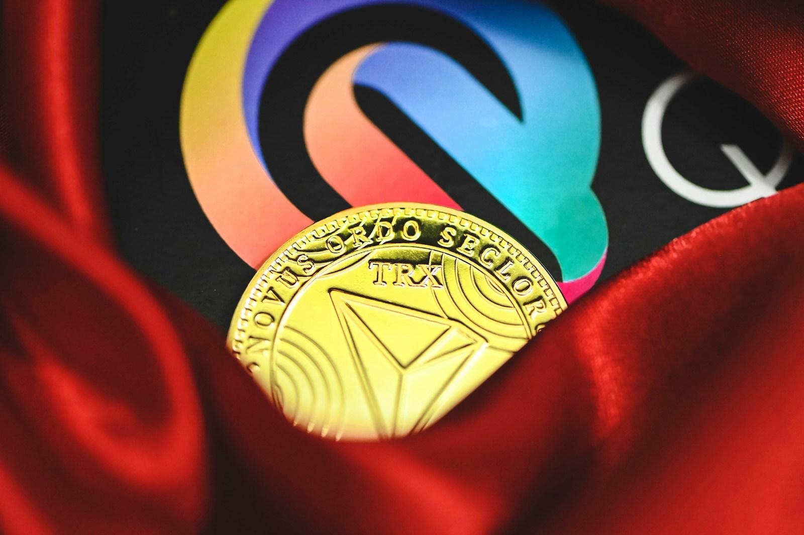 a close up of a gold coin on a red cloth